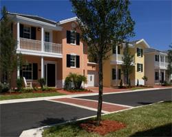 Colorful suburban houses with landscaped front yards.