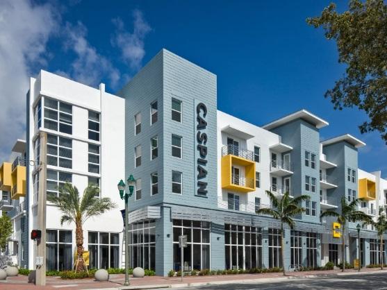 Modern apartment building with palm trees outside.