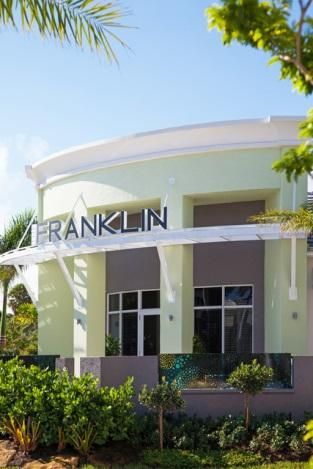 Modern building with "Franklin" sign and plants.