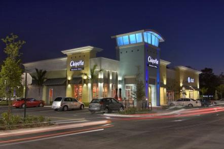 Modern restaurant exterior with night lighting.