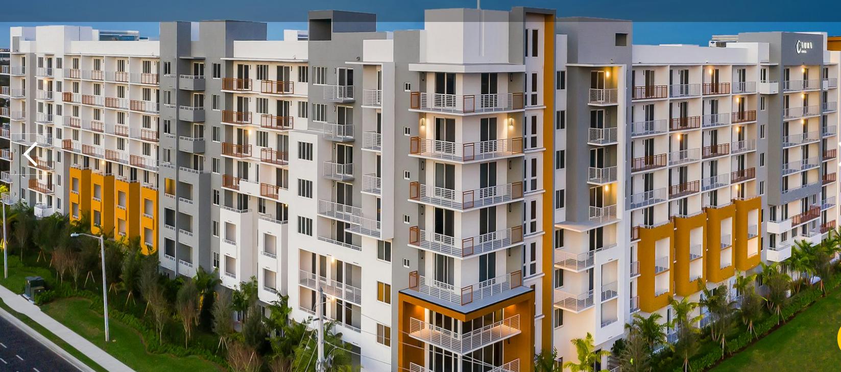 Modern apartment building with balconies and windows.