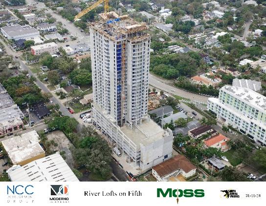 High-rise building under construction with crane.