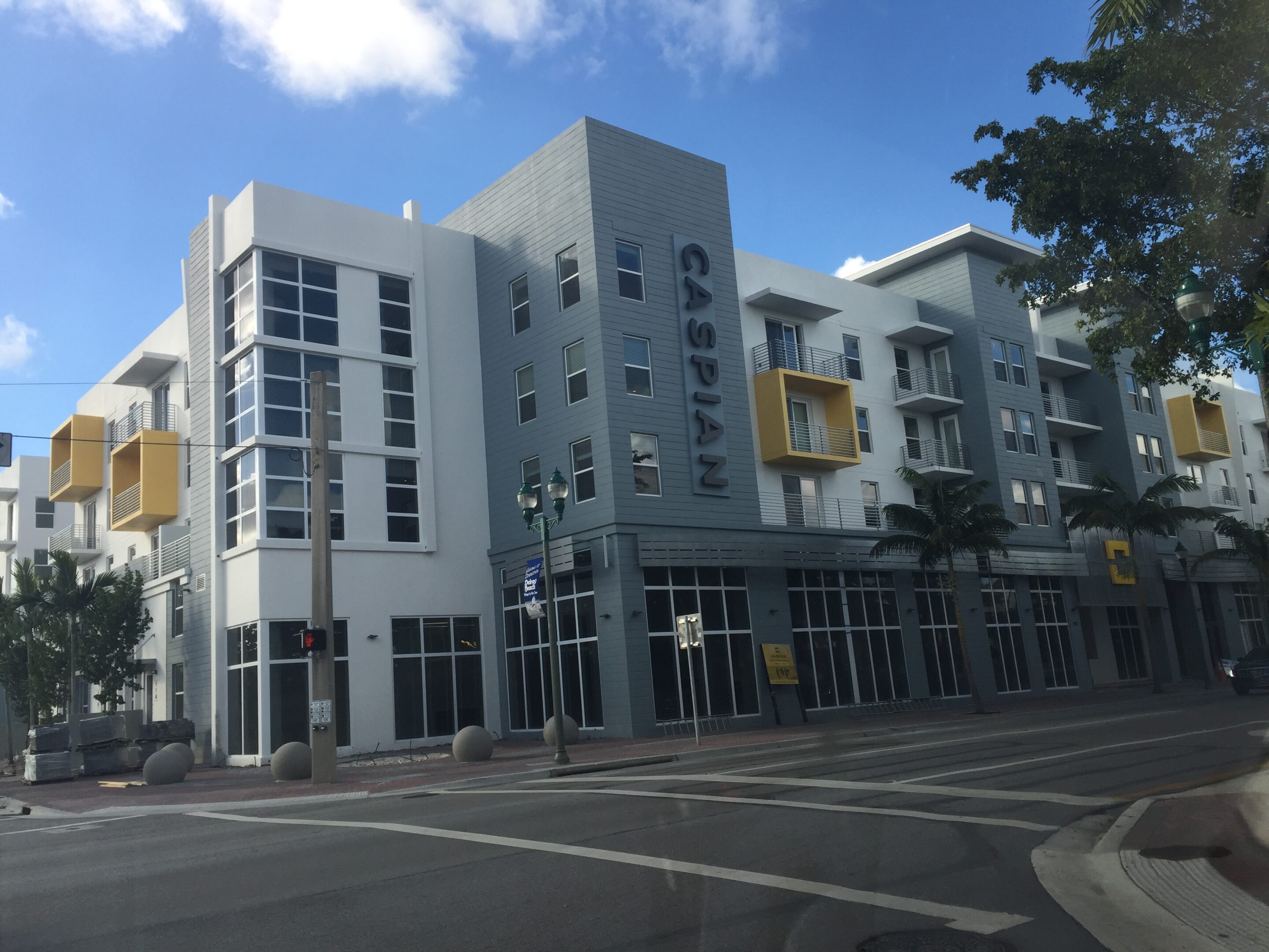 Modern apartment building with 'Capitol Lofts' signage on a sunny day.