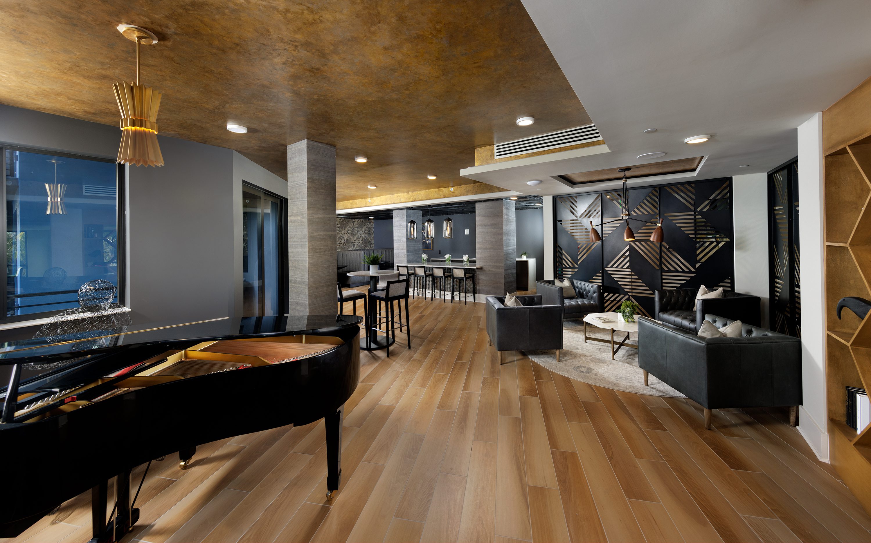 Modern lounge area with piano and stylish seating.