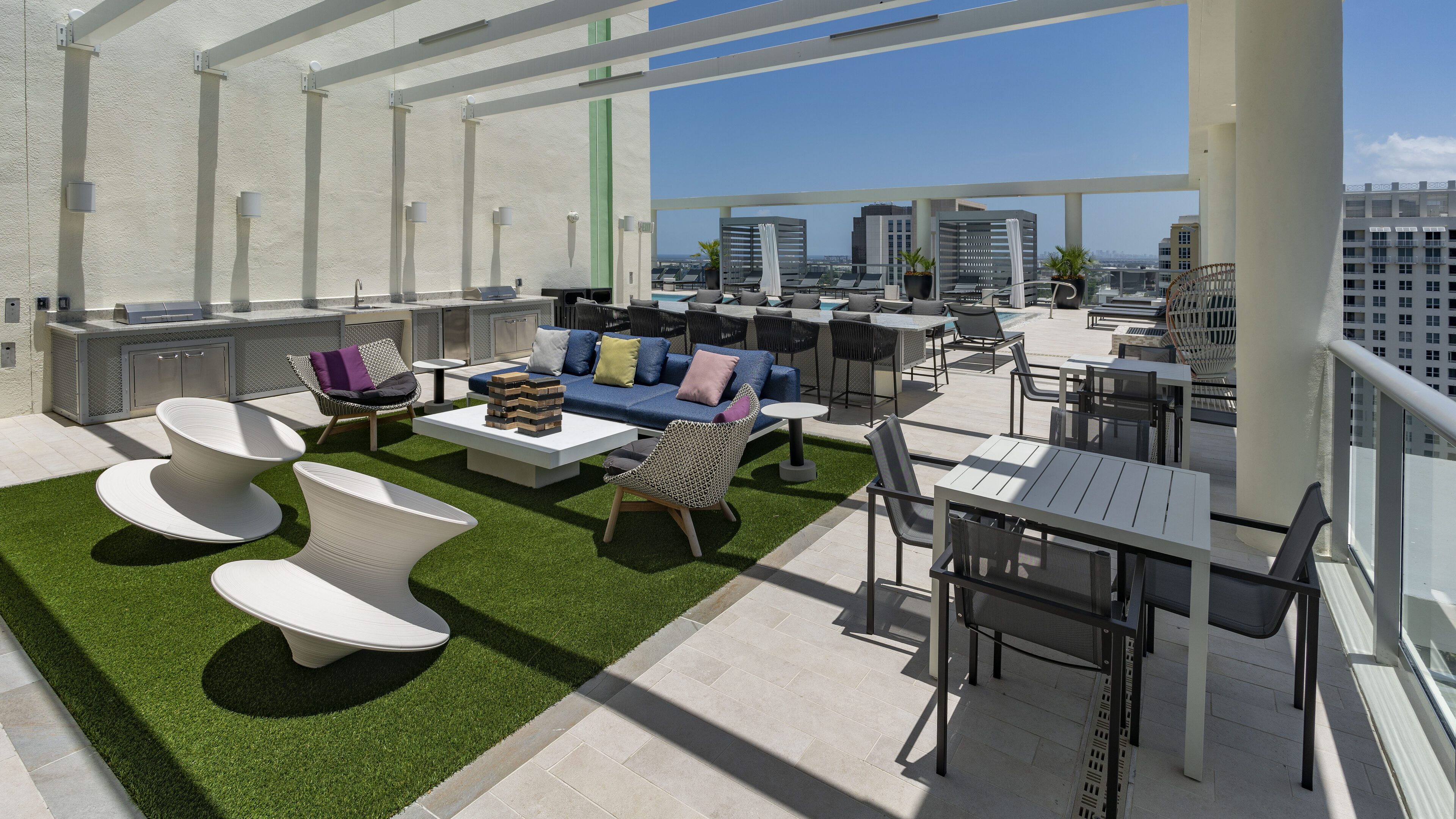 Modern rooftop lounge with comfortable seating and city views.
