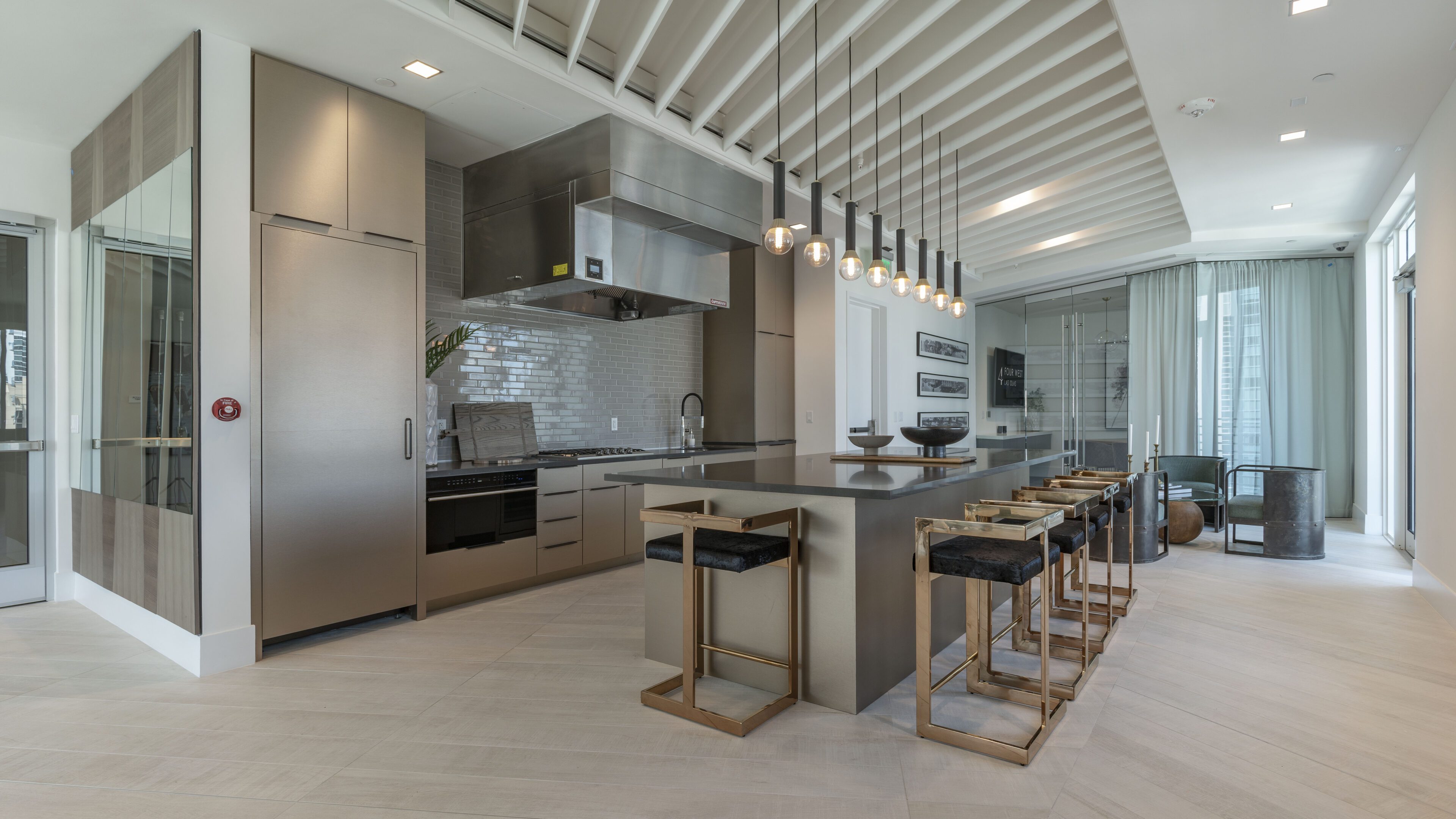 Modern kitchen with island seating and pendant lighting.