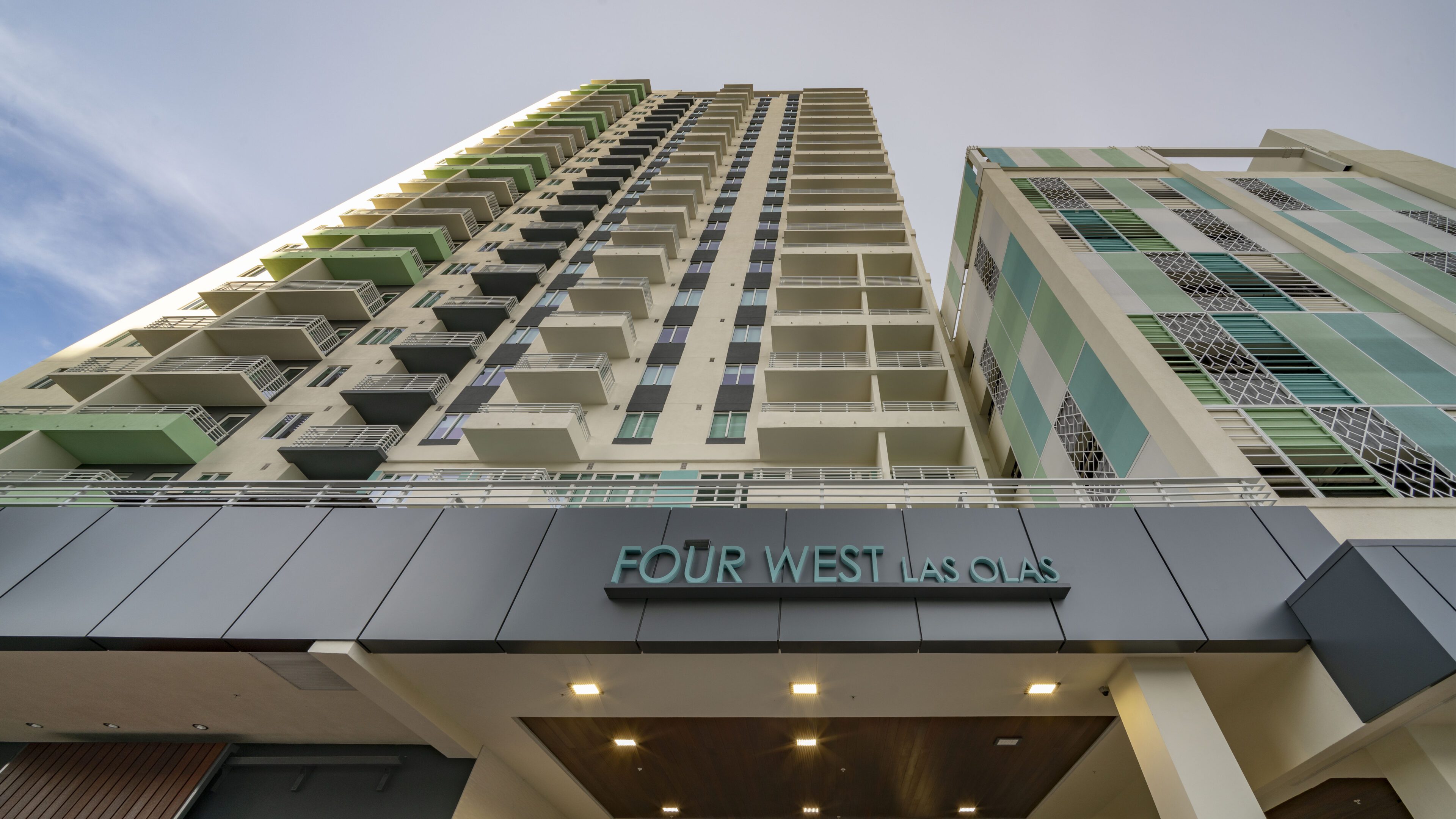 Upward view of a modern high-rise building named Four West.