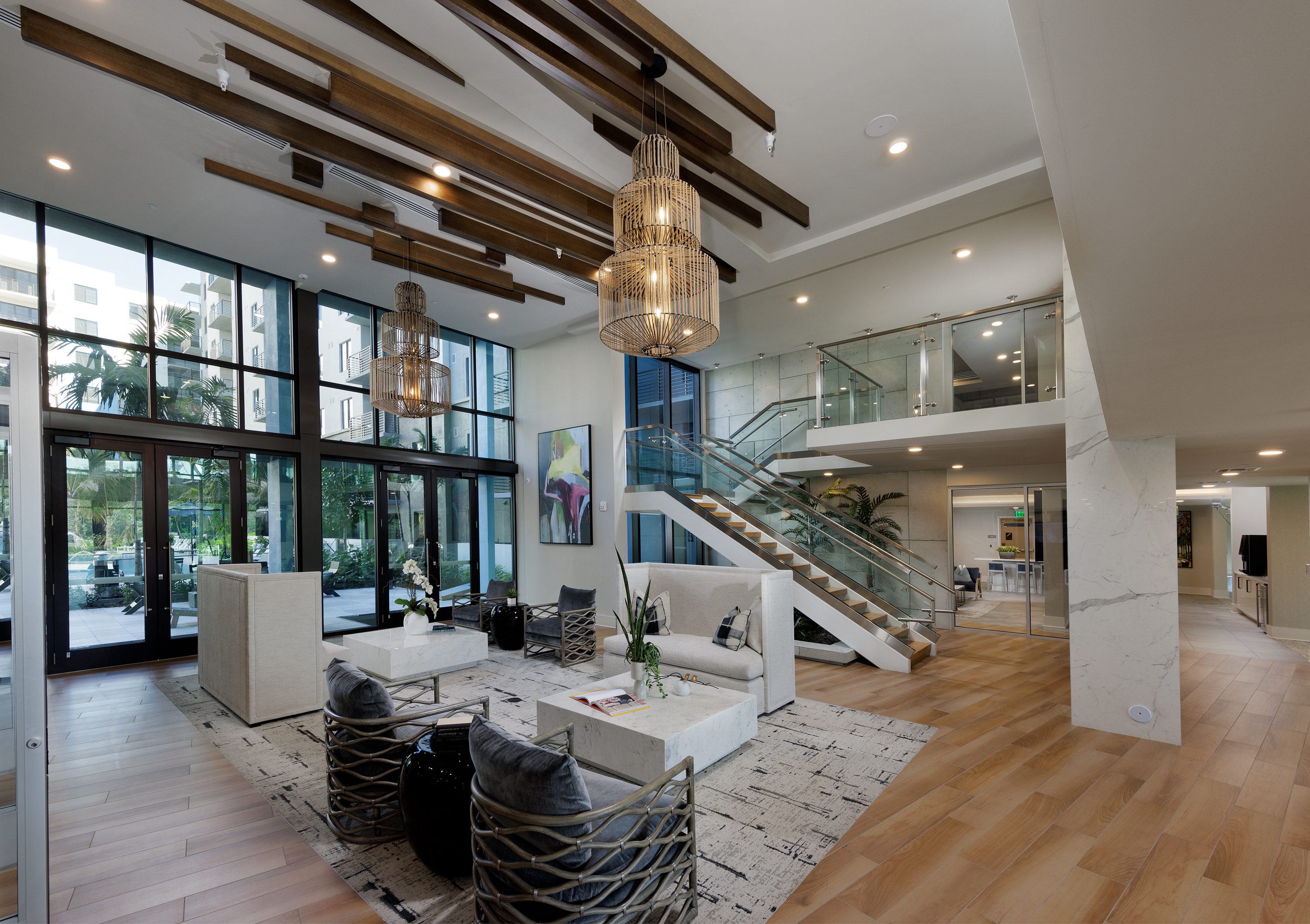 Modern living room with floor-to-ceiling windows and stylish furniture.