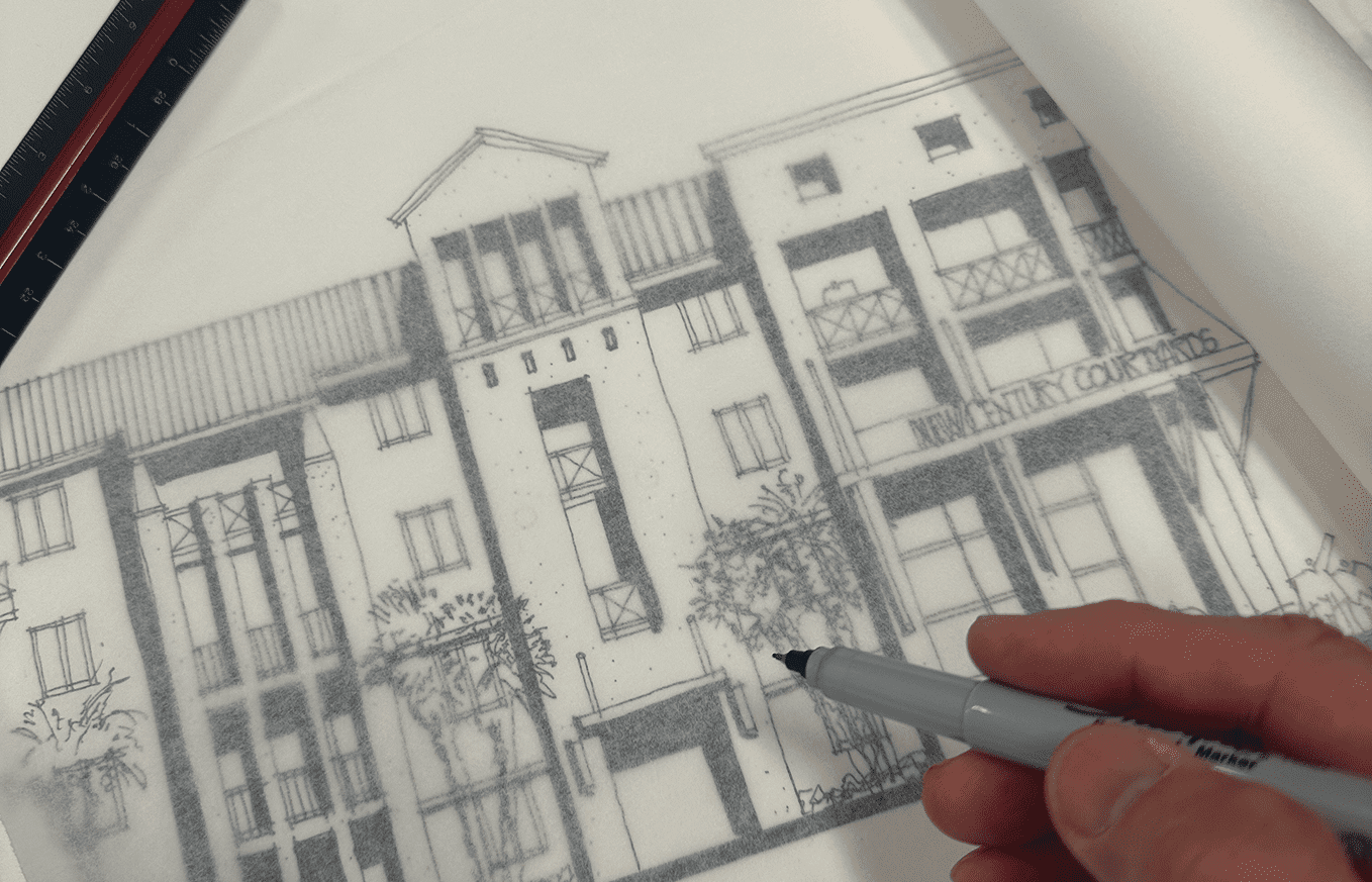 Hand pointing at architectural drawing of a multi-story residential building.