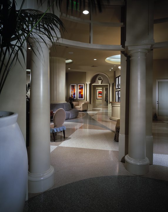 Elegant hallway with classical columns and soft lighting.