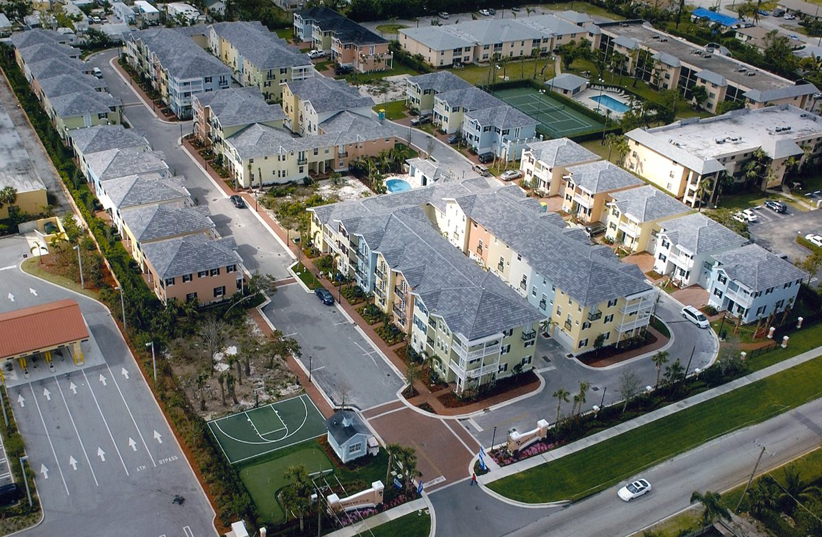Aerial view of a residential neighborhood with townhouses and streets.