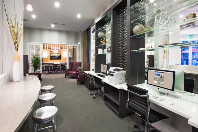 Modern office workspace with computers and seating.