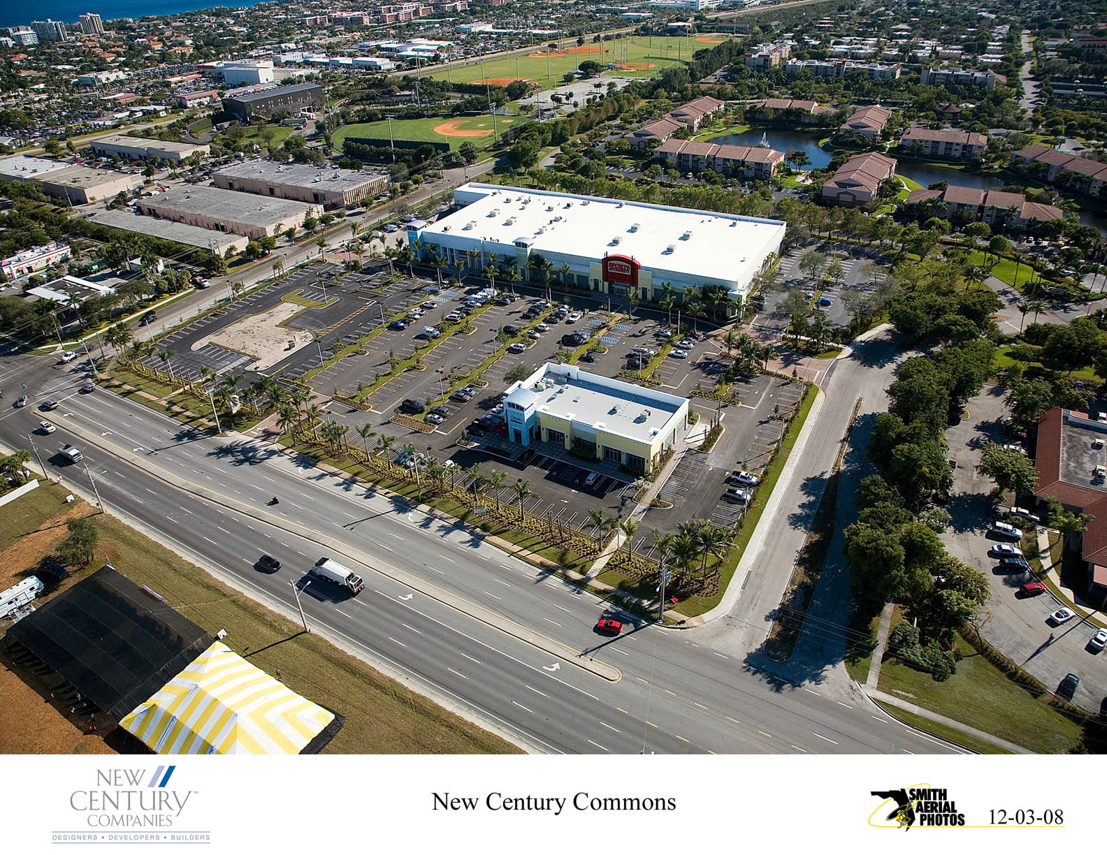 Aerial view of a commercial area with Century Condominiums building.