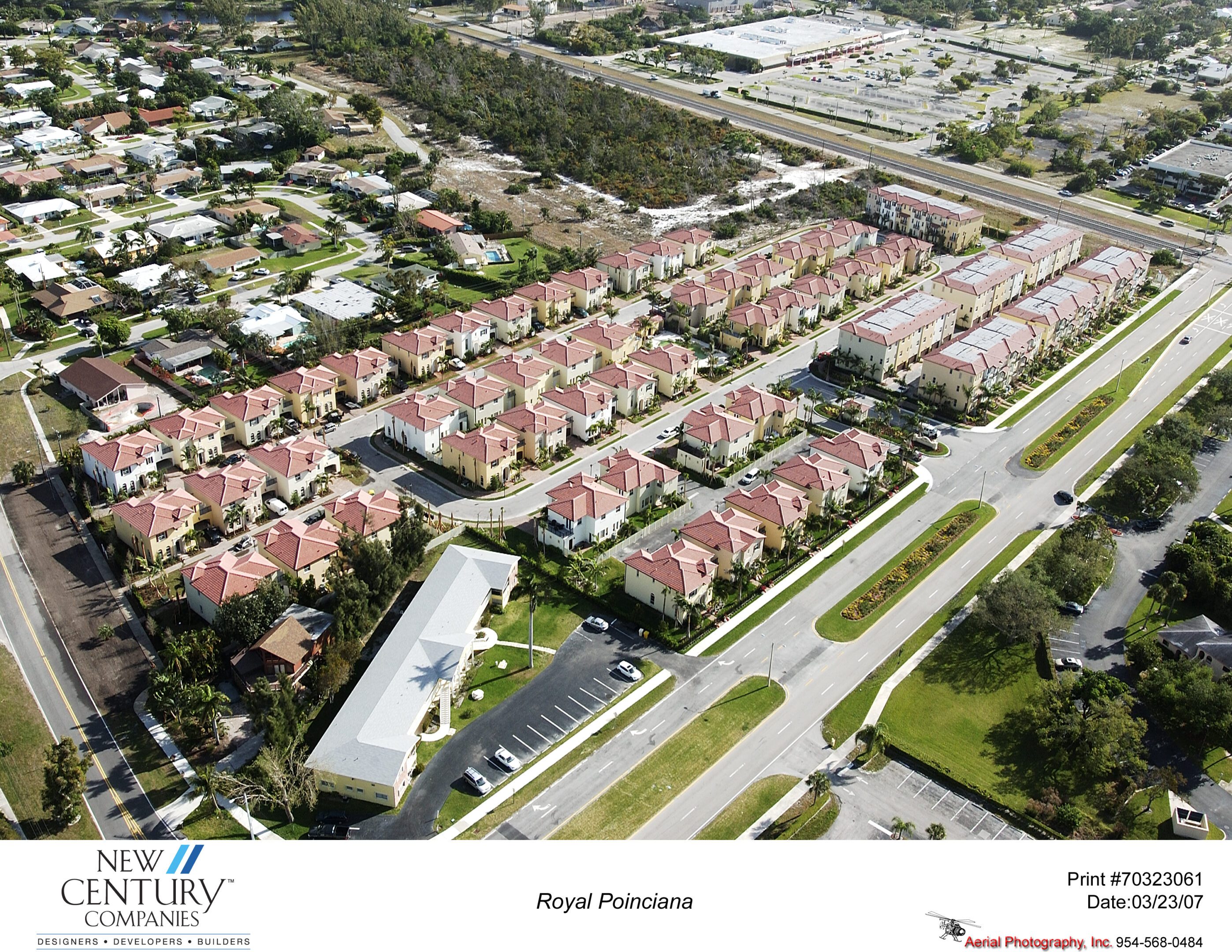 Aerial view of a residential neighborhood with rows of houses and nearby highways.